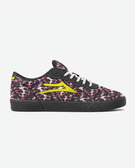 Black sneaker with pink skull pattern and yellow accents on a white background